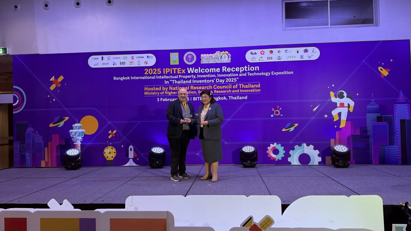 Award presentation on stage at IPITEx 2025 in Bangkok.