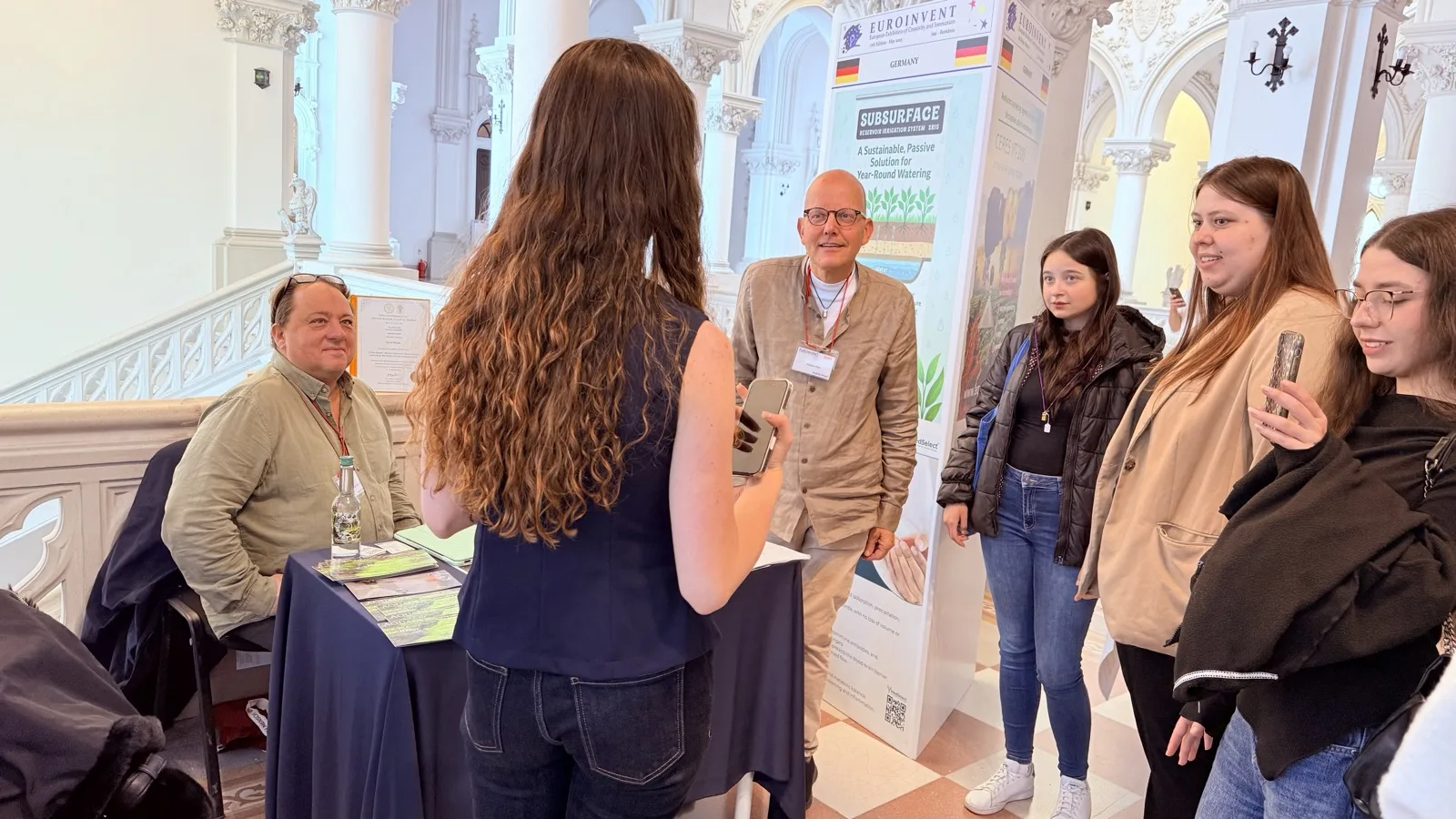 Visitor learning about an innovation at EUROINVENT 2025.
